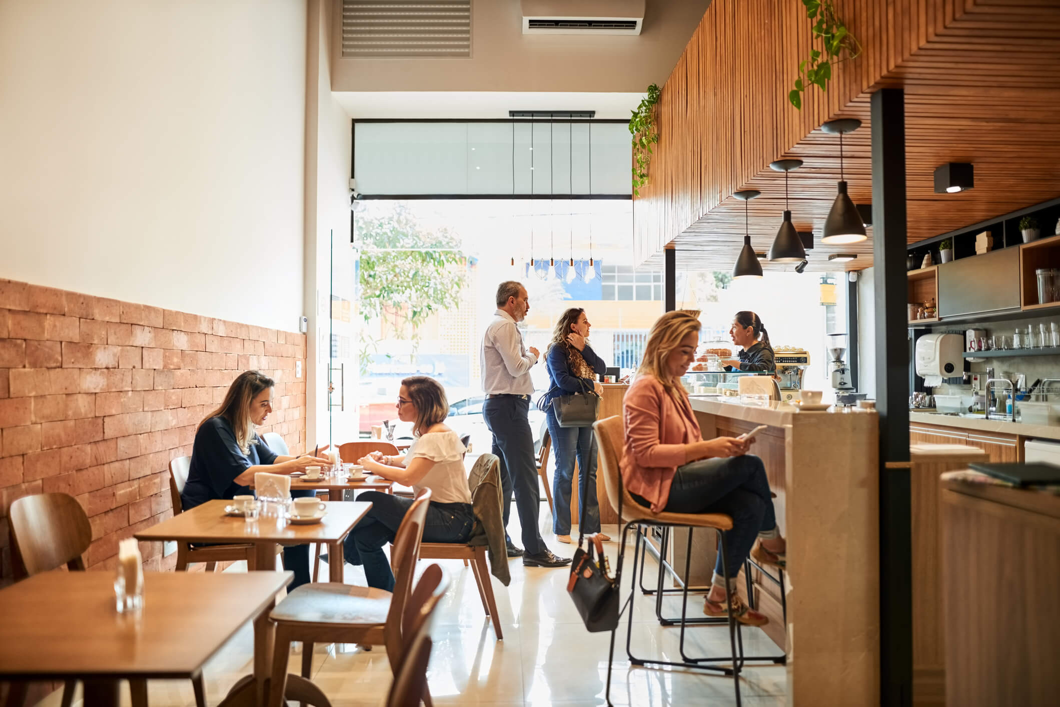 People working and relaxing inside a modern café and social gathering space