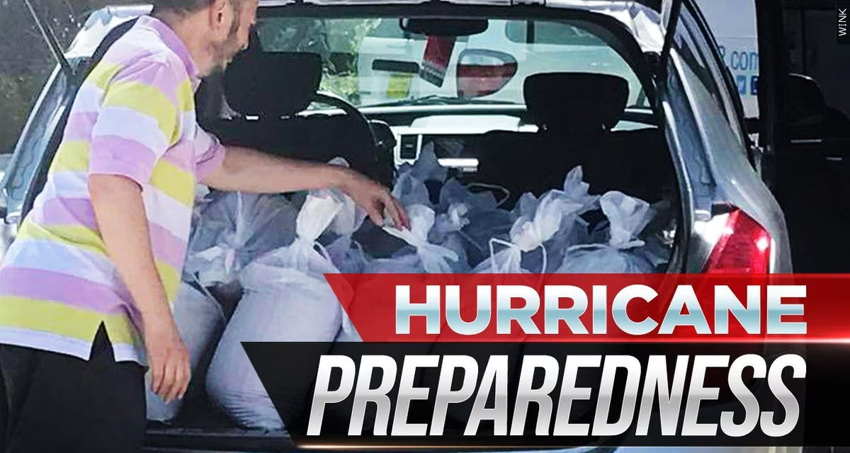 Person loading sandbags into a vehicle during hurricane preparedness efforts