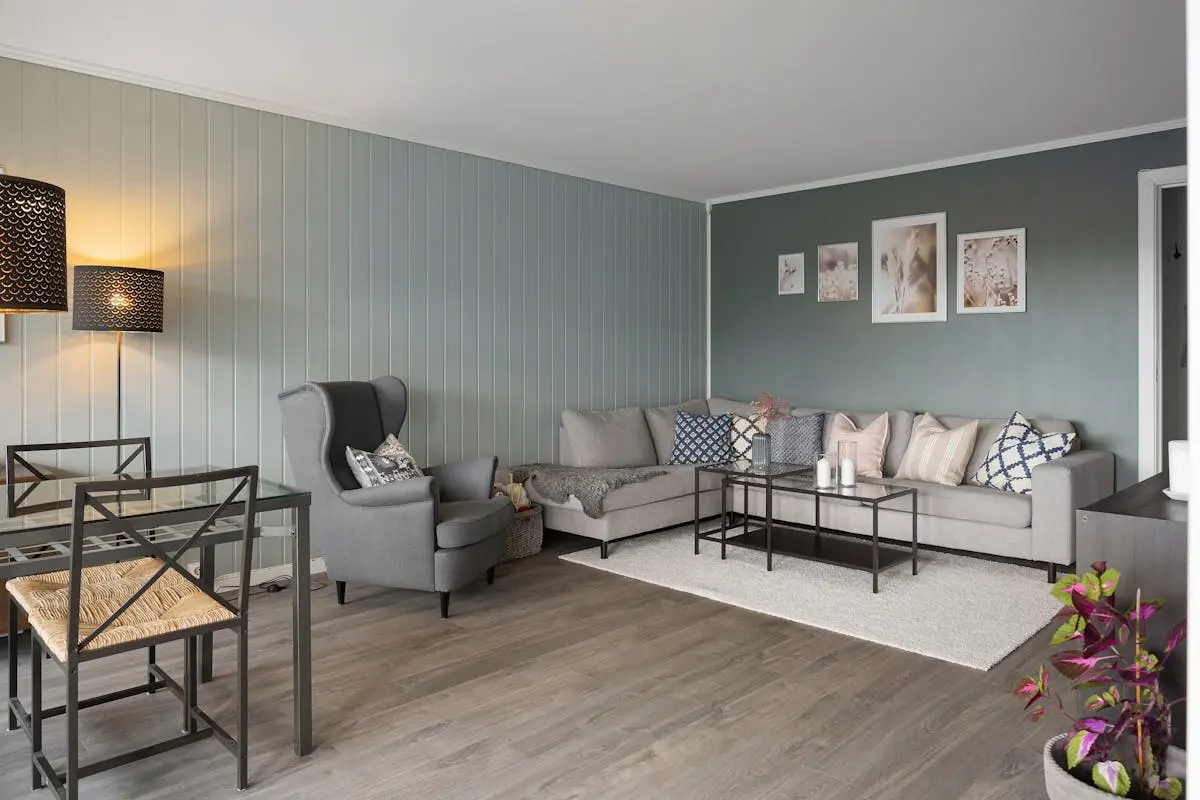 Modern furnished apartment living room with sectional sofa and dining area