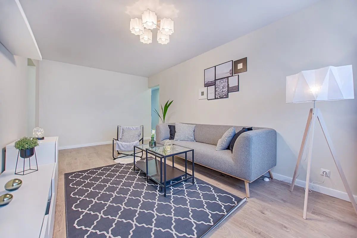 Modern furnished apartment living room with contemporary seating and minimalist décor