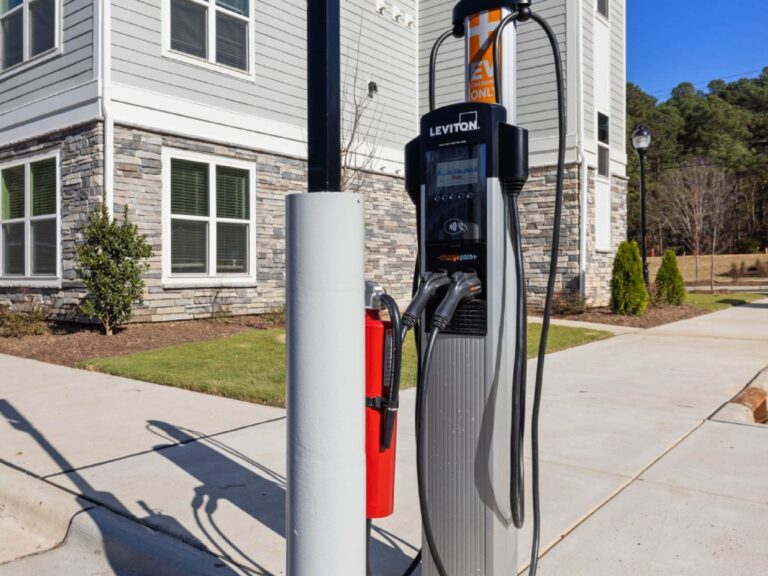 Electric vehicle charging station located at Alexander Crossing, featuring dual charging ports adjacent to the apartment community with convenient access for residents and guests.