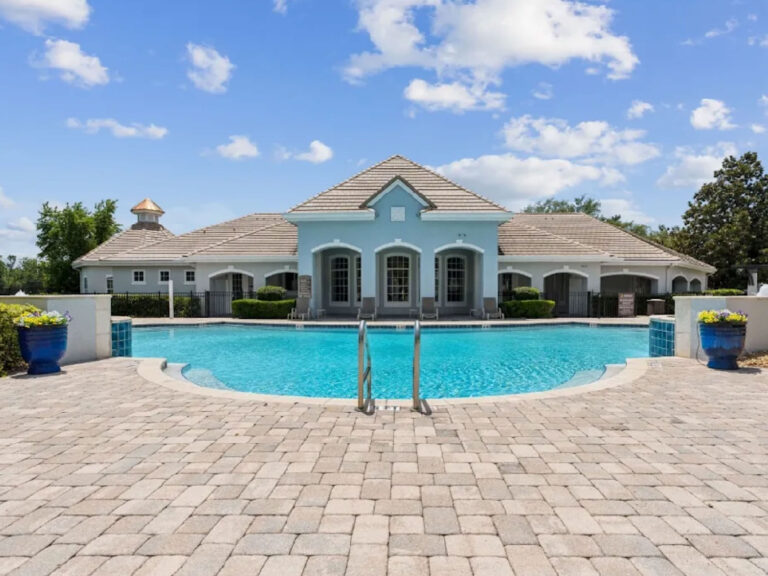 Resort style swimming pool at Ballantrae Apartments in Sanford with clubhouse, lounge seating, and landscaped pool deck