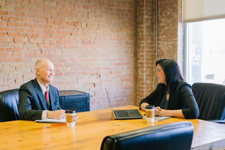 Business professionals meeting in a modern office space for corporate relocation and temporary housing coordination