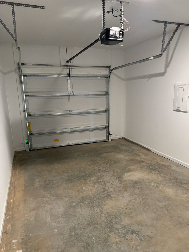Attached private garage at Covey Homes Townhomes with automatic garage door opener and enclosed parking space.