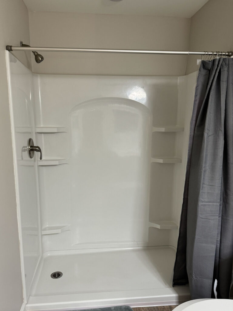 Modern walk-in shower at Evergreen at Southwood in Tallahassee featuring clean finishes and furnished apartment amenities for extended stays