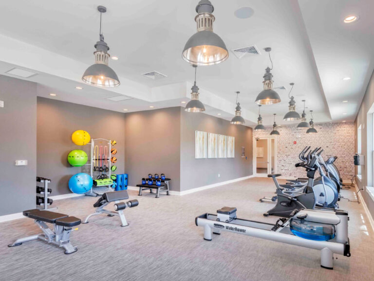 Fitness center at Evergreen at Southwood featuring cardio machines, rowing equipment, free weights, and functional training space in Tallahassee Florida