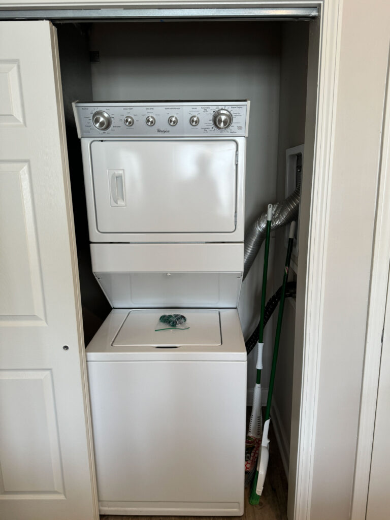 In-unit stacked washer and dryer at Evergreen at Southwood in Tallahassee providing convenient laundry access for extended stay guests