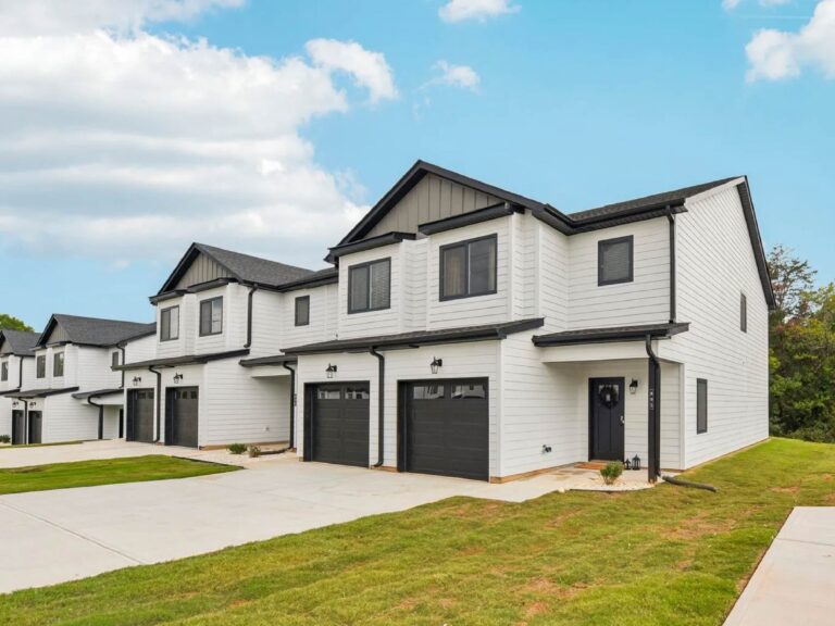 Modern two-story townhomes with attached garages, private entrances, and professionally landscaped grounds.