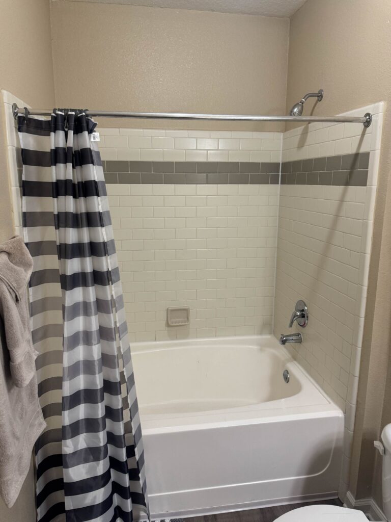 Full bathroom featuring a tub and shower combination with subway tile surround, modern fixtures, fresh linens, and a clean, well-maintained design at Waterstone at Brier Creek in Lexington, Kentucky.