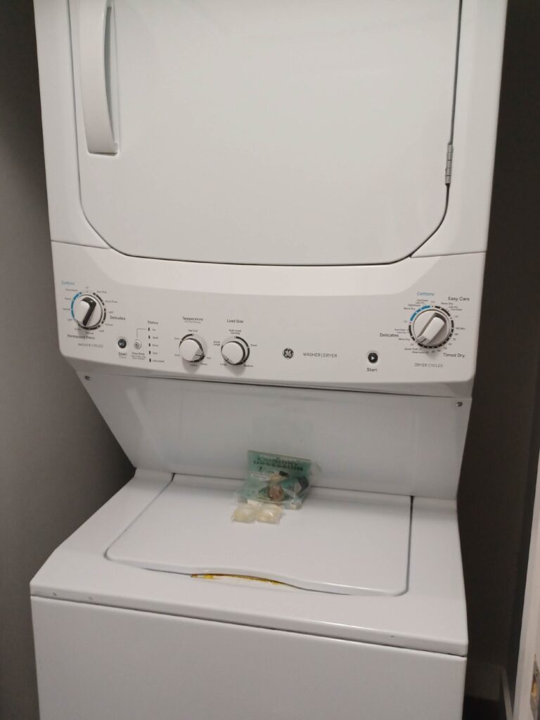 In-unit stacked washer and dryer combination located in a dedicated laundry closet.