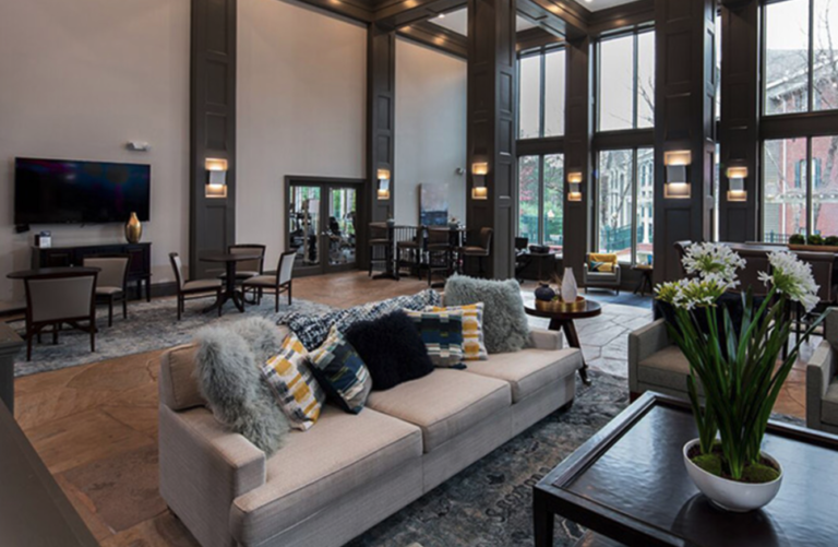 Elegant resident clubhouse at Waterford Crossing in Nashville featuring soaring ceilings, comfortable lounge seating, large windows, gathering spaces, and upscale interior finishes.