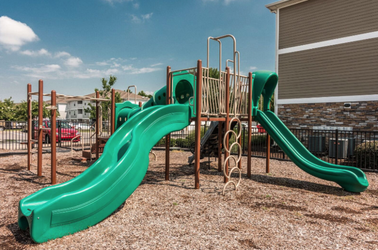 Large community playground at Waterford Crossing in Nashville featuring multiple slides, climbing structures, activity stations, and a safe mulch play surface.