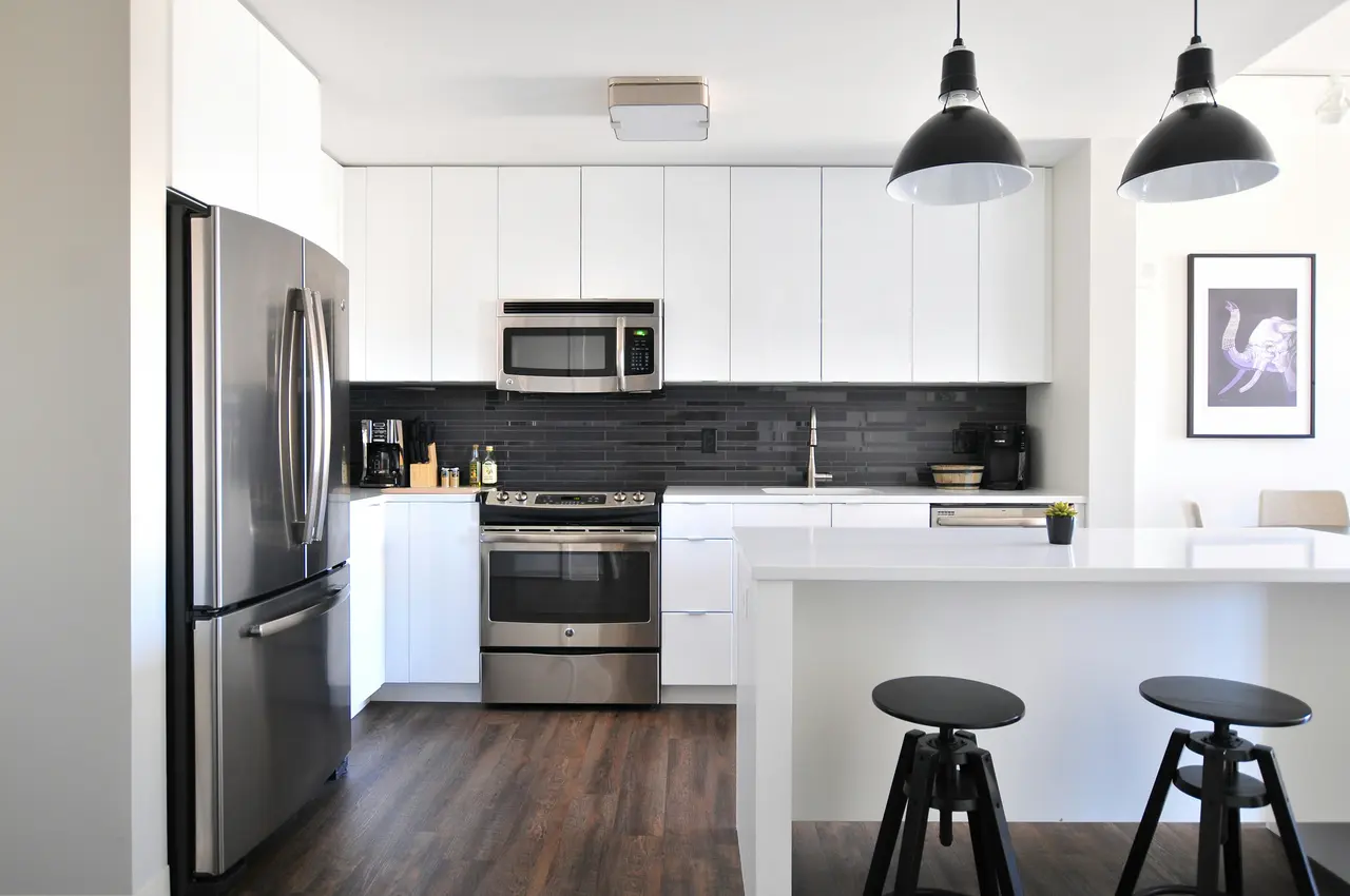 Modern furnished corporate housing kitchen with stainless steel appliances and breakfast bar