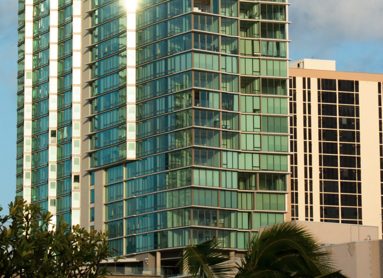 Modern Hawaii high-rise condominium tower AE O with floor-to-ceiling windows and private balconies.
