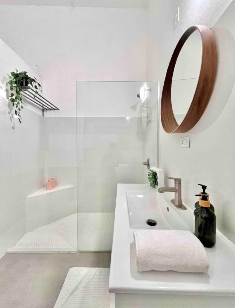 Modern Puerto Rico bathroom featuring a walk-in glass shower, floating vanity, and contemporary fixtures.